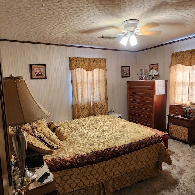 bedroom featuring light carpet, a textured ceiling, and ceiling fan