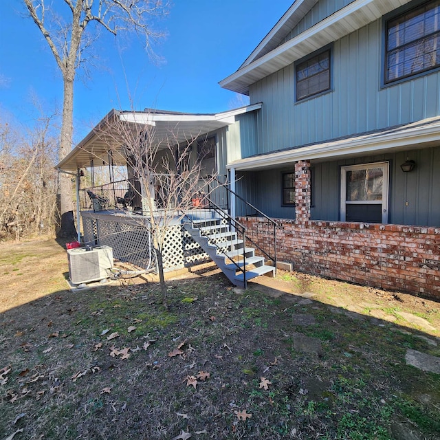 view of side of property featuring covered porch