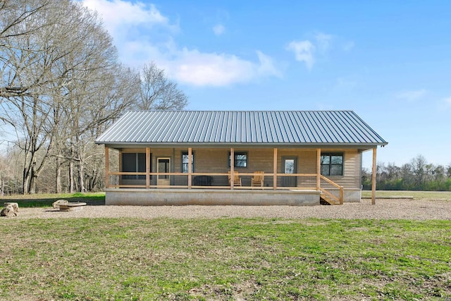 rear view of property featuring a porch and a lawn