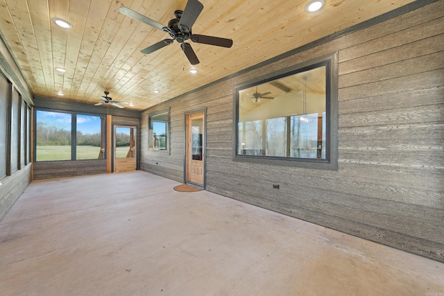 unfurnished sunroom with wood ceiling and ceiling fan