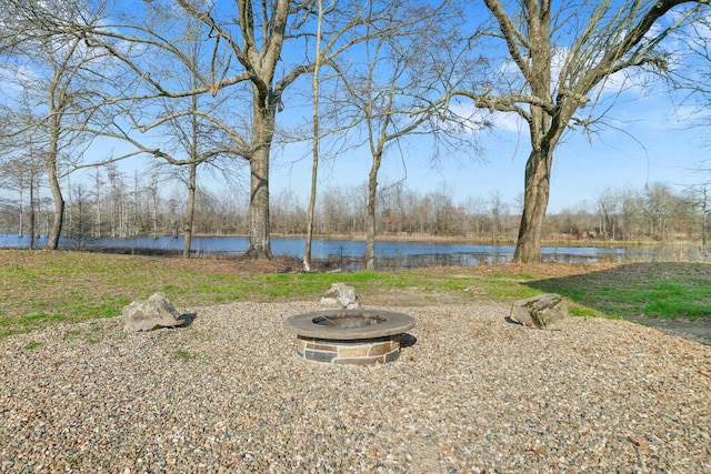 view of yard featuring a fire pit and a water view