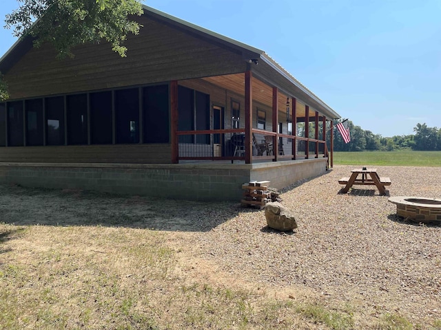 view of property exterior with a fire pit