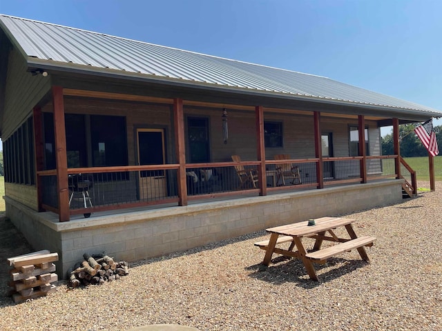 rear view of property featuring a porch