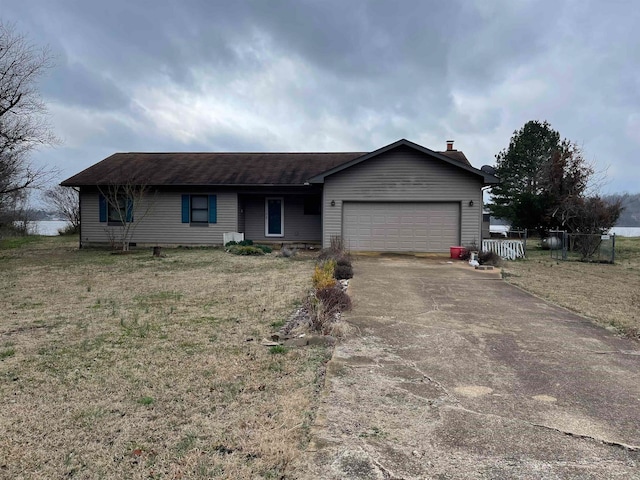 single story home with a garage and a front lawn