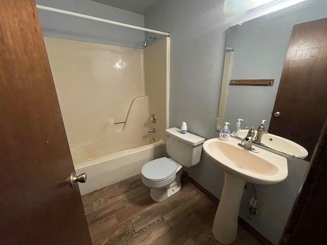 full bathroom featuring sink, toilet, bathtub / shower combination, and hardwood / wood-style floors