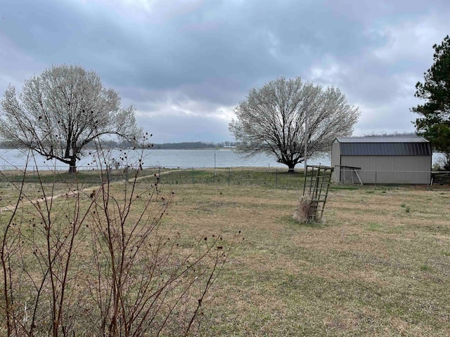 view of yard with a water view and an outdoor structure