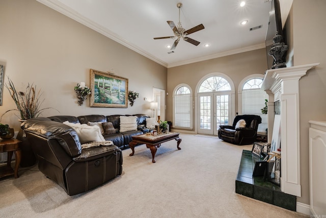 carpeted living room with crown molding and ceiling fan