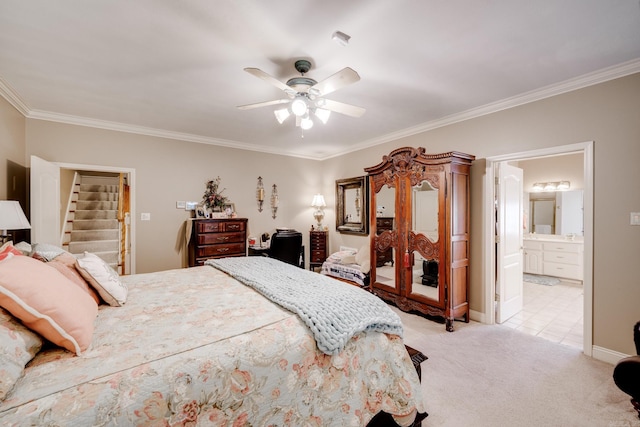 carpeted bedroom featuring crown molding, connected bathroom, and ceiling fan