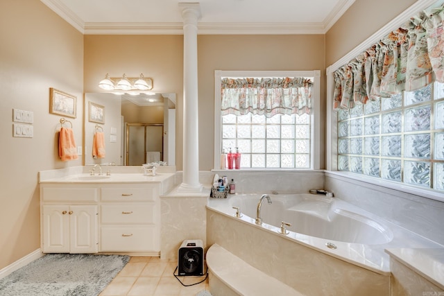 bathroom featuring tile flooring, vanity with extensive cabinet space, ornamental molding, decorative columns, and a washtub