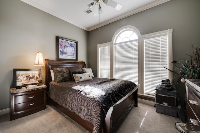 carpeted bedroom with ceiling fan and crown molding