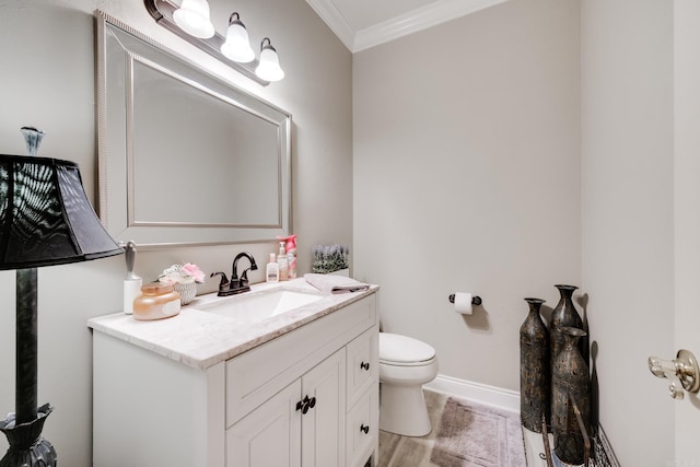 bathroom with hardwood / wood-style floors, crown molding, oversized vanity, and toilet