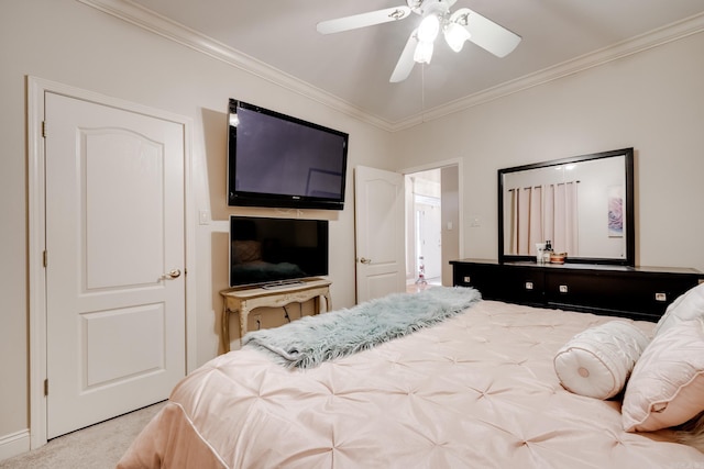 carpeted bedroom featuring crown molding and ceiling fan