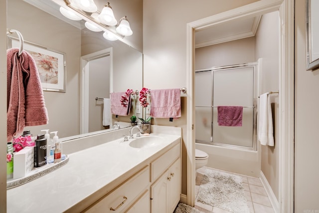 full bathroom with toilet, crown molding, tile flooring, oversized vanity, and bath / shower combo with glass door