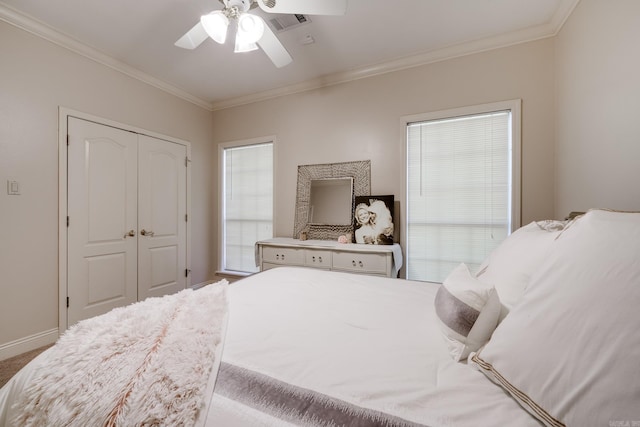 bedroom with ceiling fan, crown molding, a closet, and multiple windows