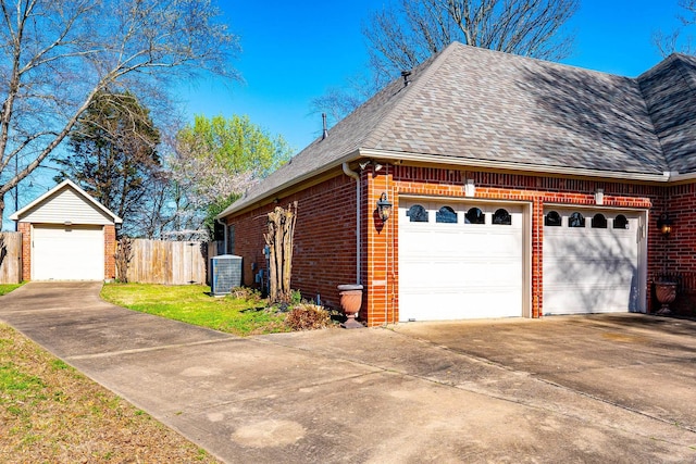 view of front of property featuring central AC and a garage