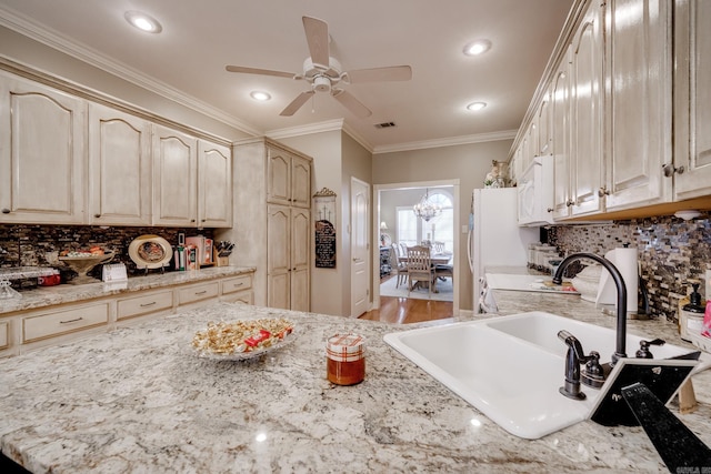 kitchen with ceiling fan, sink, tasteful backsplash, and wood-type flooring