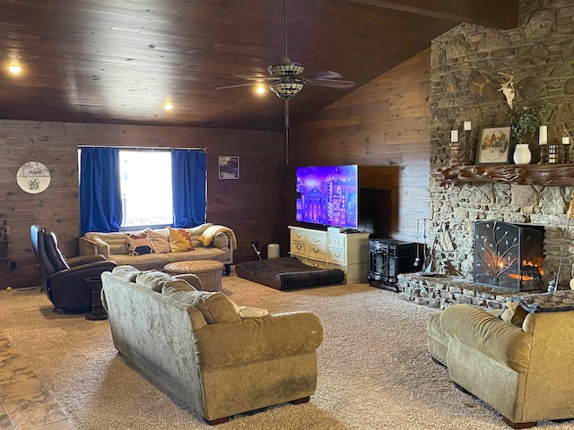 living room featuring ceiling fan, wood ceiling, carpet, a fireplace, and wood walls