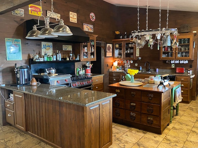 kitchen with light tile flooring, dark stone counters, wooden walls, sink, and electric stove