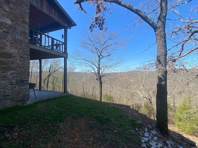 view of yard with a balcony and a patio