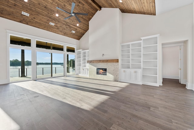 unfurnished living room featuring ceiling fan, high vaulted ceiling, wooden ceiling, a premium fireplace, and wood finished floors