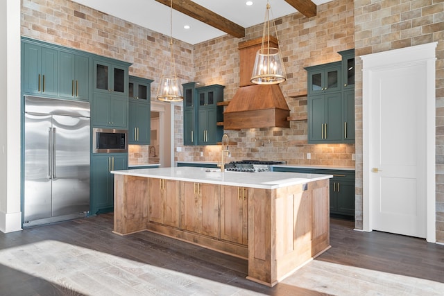 kitchen featuring built in appliances, light countertops, dark wood finished floors, and beam ceiling