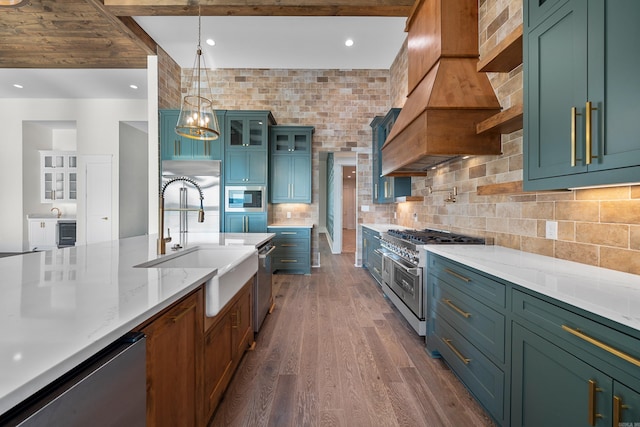 kitchen featuring tasteful backsplash, light stone counters, appliances with stainless steel finishes, dark wood-type flooring, and a sink