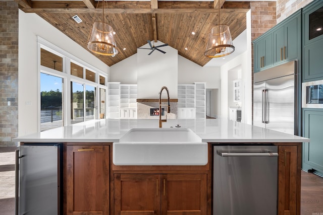 kitchen with stainless steel appliances, high vaulted ceiling, a sink, and wood ceiling