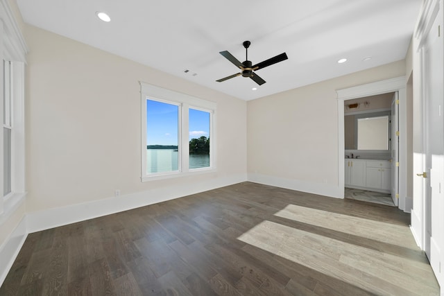 empty room featuring baseboards, wood finished floors, and recessed lighting