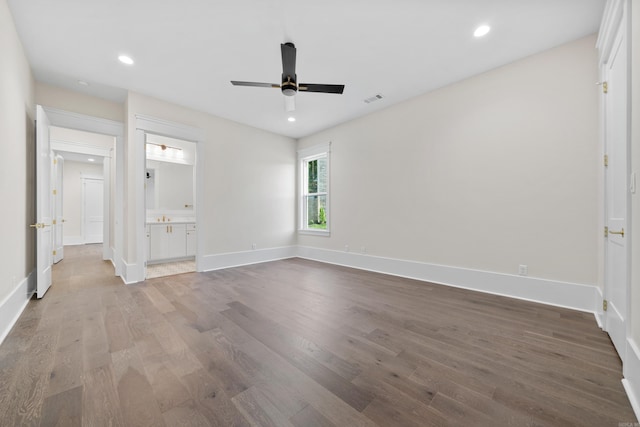 unfurnished room with baseboards, visible vents, wood finished floors, and recessed lighting