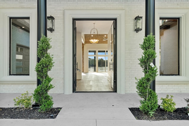 property entrance featuring brick siding