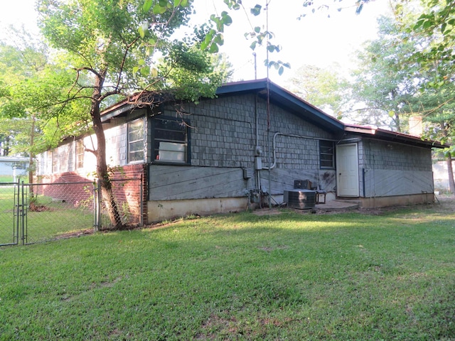 view of side of home with a lawn