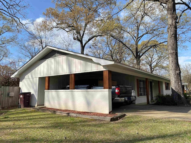 view of side of property with a carport and a yard