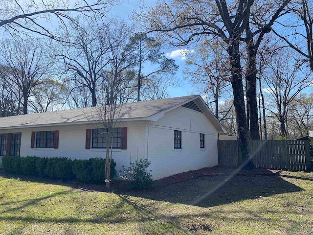 view of side of property with a yard