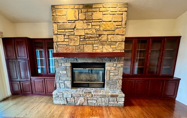 unfurnished living room featuring light wood-type flooring and a fireplace