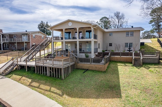 back of house featuring a balcony and a lawn