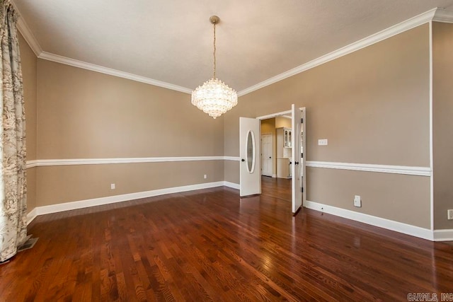 spare room with dark hardwood / wood-style flooring, an inviting chandelier, and ornamental molding