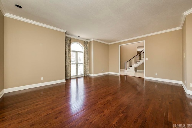 spare room featuring dark hardwood / wood-style flooring, crown molding, and a textured ceiling