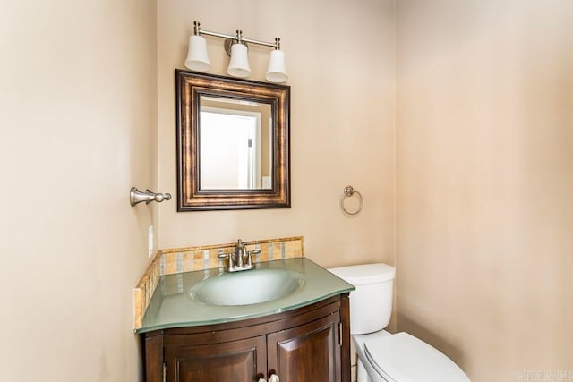 bathroom featuring toilet and large vanity