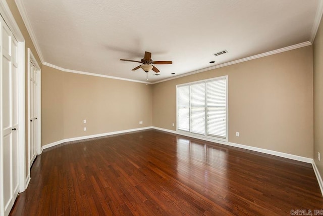 unfurnished bedroom with ceiling fan, dark wood-type flooring, and ornamental molding