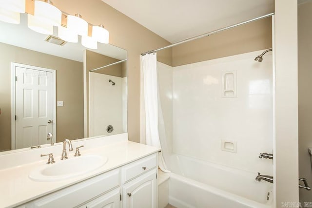 bathroom with shower / bath combo and vanity