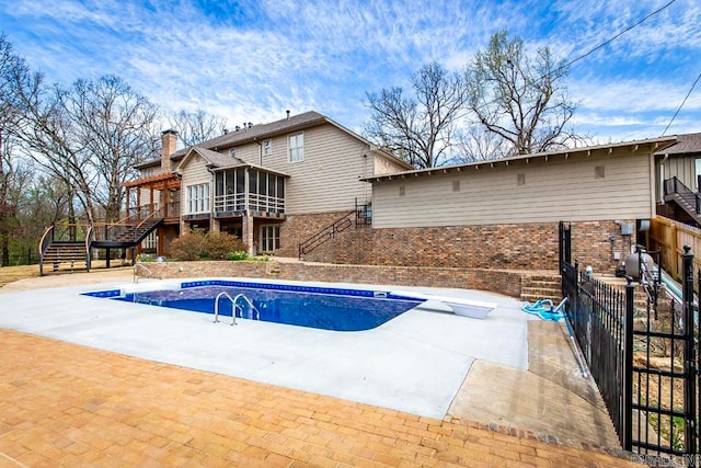 view of swimming pool featuring a wooden deck and a patio