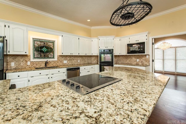 kitchen featuring backsplash, light stone counters, and black appliances