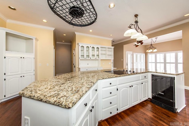 kitchen featuring white cabinets, a kitchen island, a notable chandelier, and dark hardwood / wood-style flooring