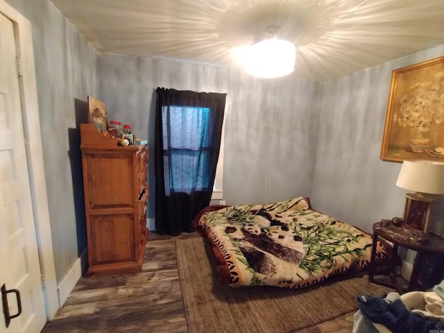 bedroom featuring dark hardwood / wood-style flooring