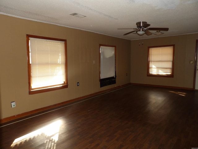 unfurnished room featuring ceiling fan, dark wood-type flooring, and a textured ceiling