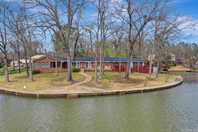 dock area with a water view and a lawn