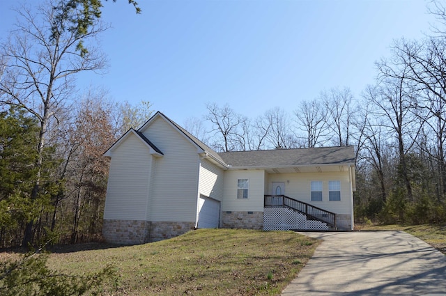 view of front facade with a front yard and a garage