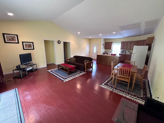 living room featuring lofted ceiling and dark hardwood / wood-style flooring