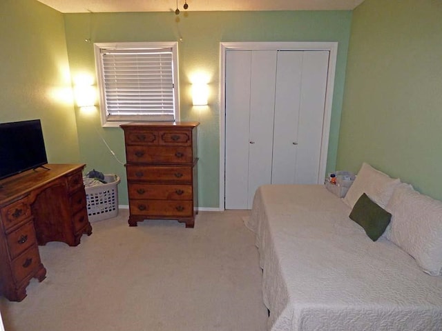 bedroom with a closet and light colored carpet