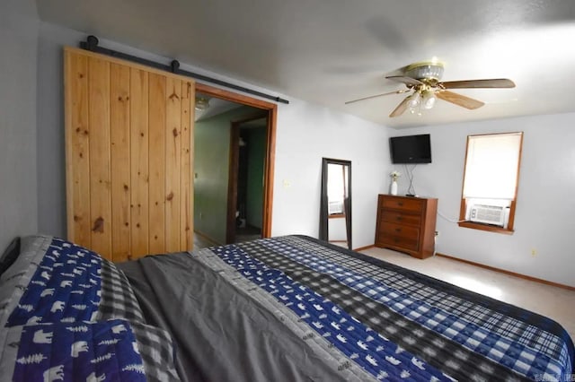 bedroom with a barn door, carpet floors, a closet, cooling unit, and ceiling fan